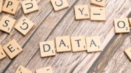 scrabble tiles spelling out the word data on a wooden surface