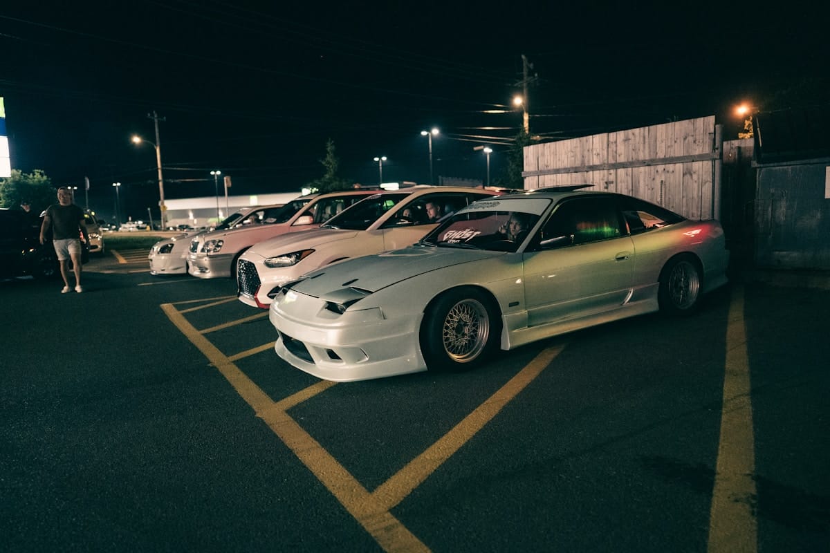 a group of cars parked next to each other in a parking lot