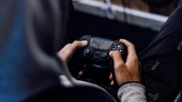 a person holding a game controller in their hands