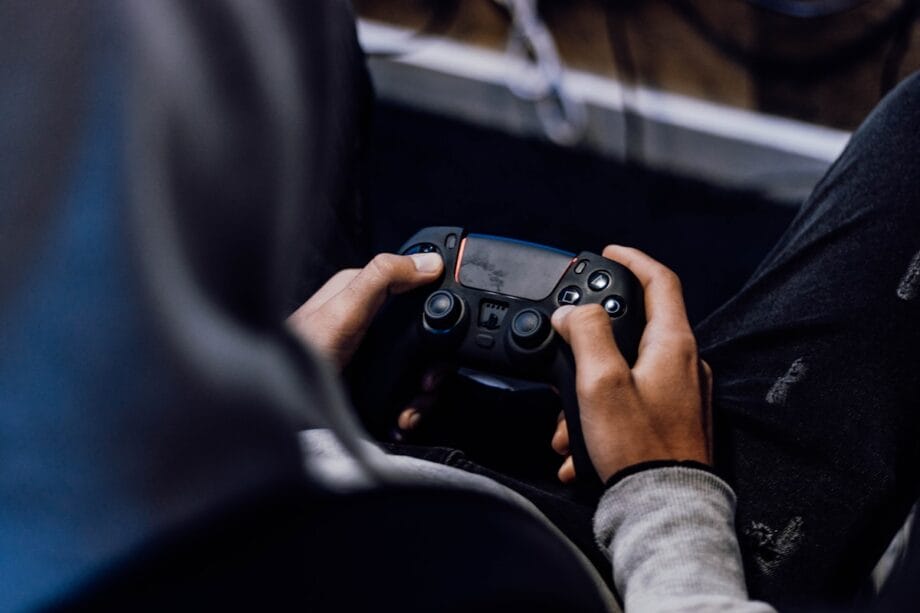 a person holding a game controller in their hands