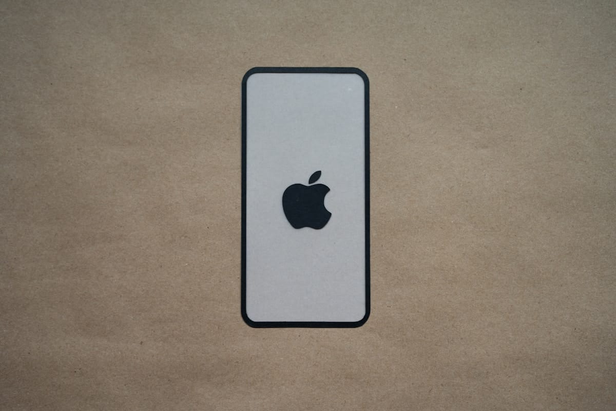 an iphone is sitting on a brown surface