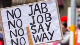 A protest sign reads NO JAB NO JOB NO SAY NO WAY at a public demonstration.