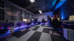 A group of people sitting in a room with a checkered floor