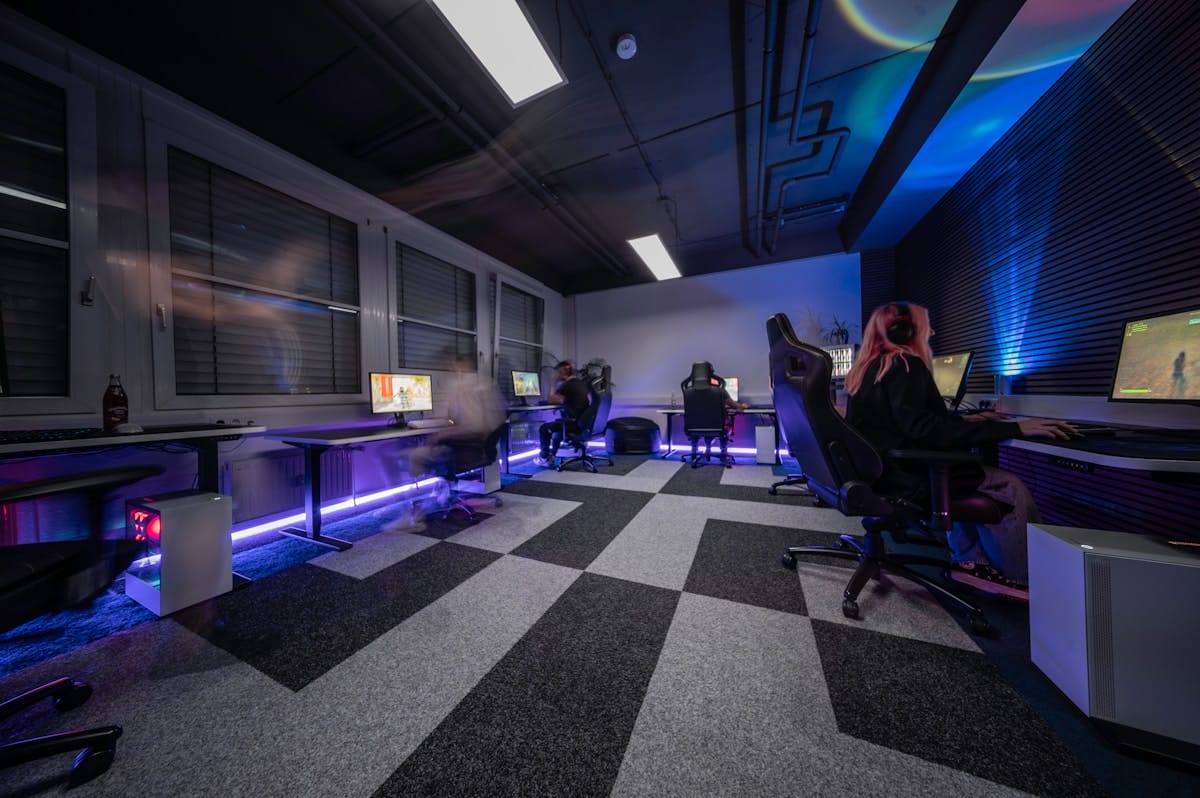 A group of people sitting in a room with a checkered floor