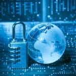 A combination padlock and a glass globe sit on a circuit board, symbolizing cybersecurity and data protection.
