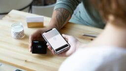 a person sitting at a table with a cell phone