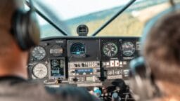 A man sitting in the cockpit of a plane