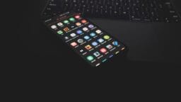 black iphone 5 on black computer keyboard