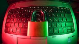 pink and silver padlock on black computer keyboard