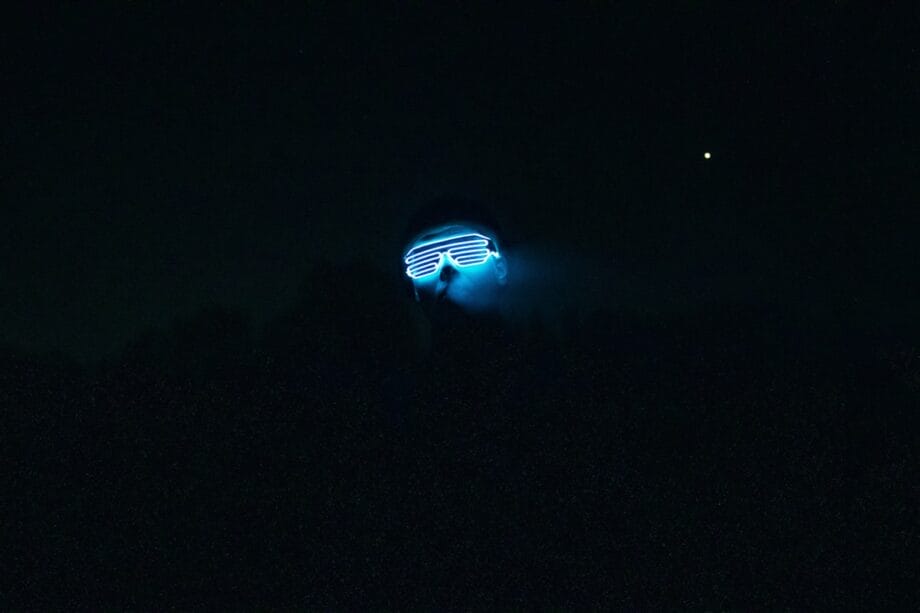 a person with a light on their face in the dark