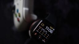 a smart watch sitting next to an iphone
