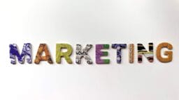 The word “MARKETING” spelled out in colorful, patterned block letters on a plain white background.