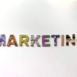The word MARKETING spelled out in colorful, patterned capital letters on a plain white background.