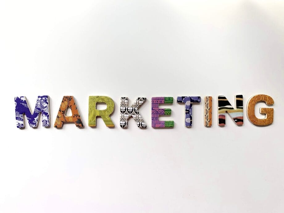 The word MARKETING spelled out in colorful, patterned capital letters on a plain white background.