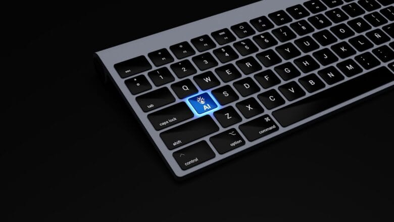 Partial view of a keyboard with a highlighted blue key labeled AI featuring a hand icon, set against a black background.