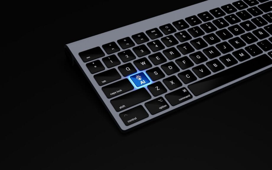 Partial view of a keyboard with a highlighted blue key labeled AI featuring a hand icon, set against a black background.