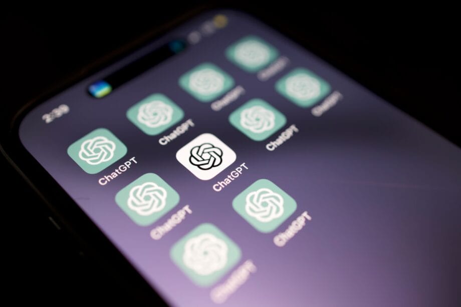 A smartphone screen displays multiple ChatGPT app icons with a dark background.