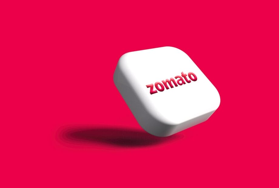 A white rounded square with the word zomato in red letters on it against a solid bright pink background.