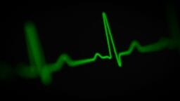 a green heart beat on a black background