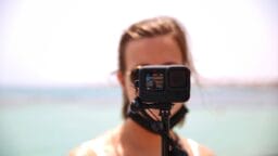 a woman holding a camera in front of her face