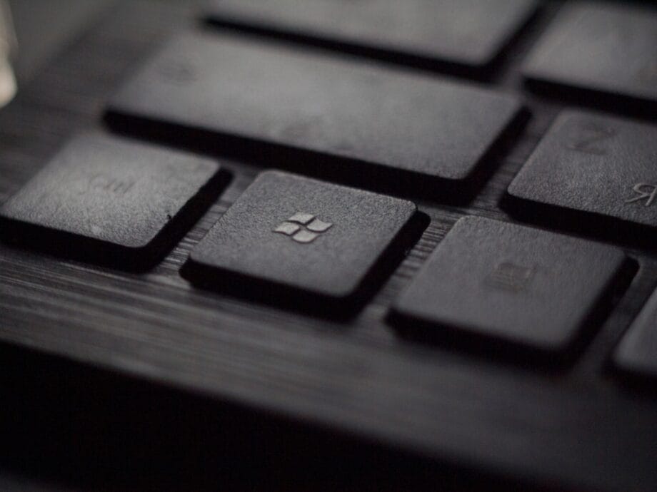 Close-up of a black keyboard with the Windows logo key in focus.