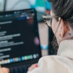 A woman looking at a computer screen.