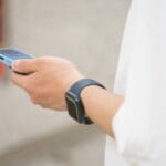 a person holding a smart phone in their hand