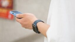 a person holding a smart phone in their hand