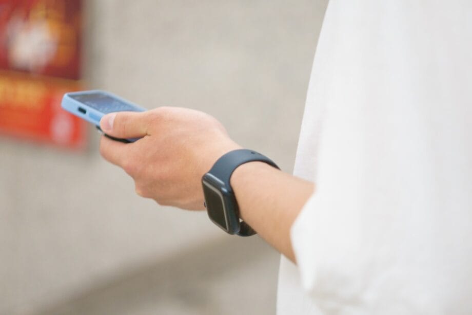 a person holding a smart phone in their hand