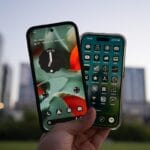 Two smartphones held up against city skyline