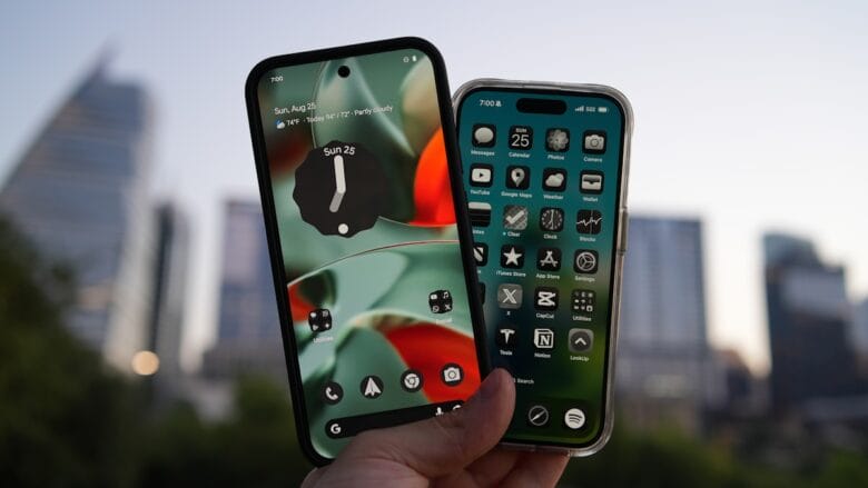 Two smartphones held up against city skyline