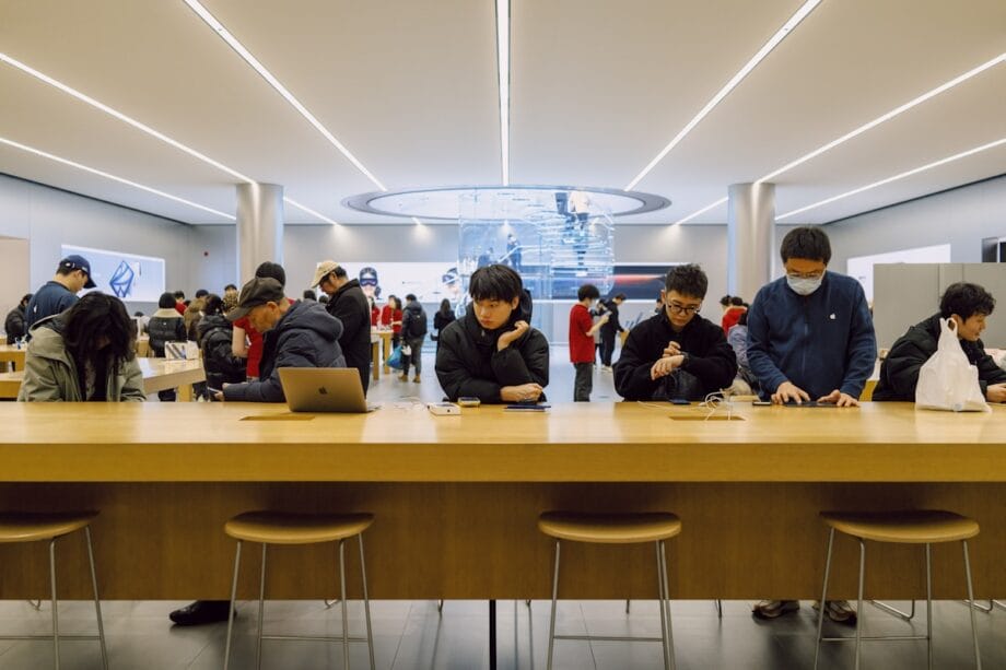People using devices at an apple store.