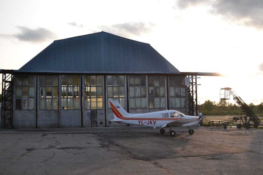 a small airplane parked in front of a building