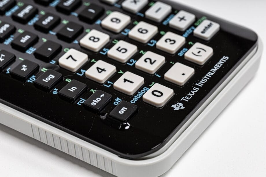 Close-up of a Texas Instruments scientific calculator showing various buttons and functions on its keypad.