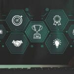 Person at keyboard with floating hexagon icons showing target, handshake, trophy, ribbon, clock, money, and lightbulb symbols.