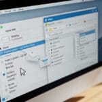 A computer screen displays an email being dragged from Apple Mail to Outlook on a desktop interface.