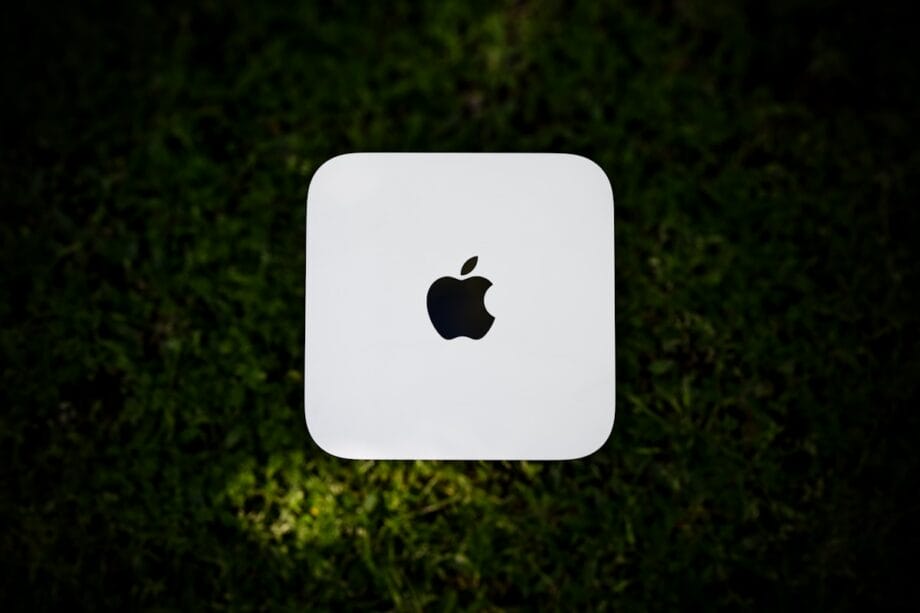 White apple computer on green grass