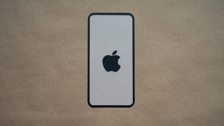 an iphone is sitting on a brown surface