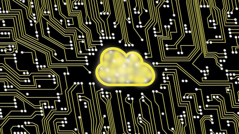 Yellow cloud icon at the center of a black circuit board pattern with yellow and white lines and nodes.