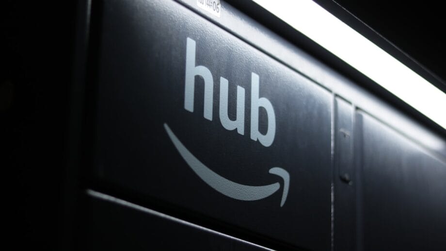 Close-up of an Amazon Hub locker with the Amazon logo and hub text under a fluorescent light.