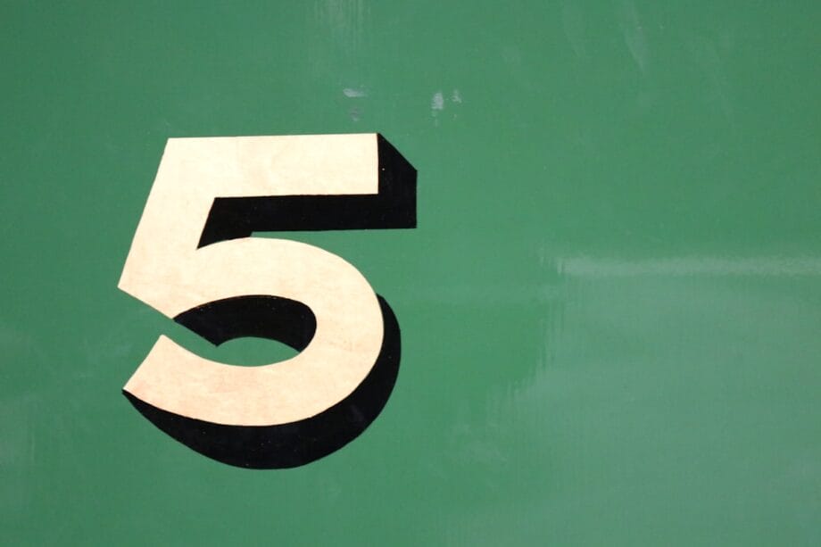 A large, beige number 5 with a black shadow is displayed on a solid green background.
