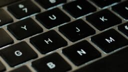 Close-up view of a black computer keyboard showing the letter keys H, J, K, Y, U, and N.