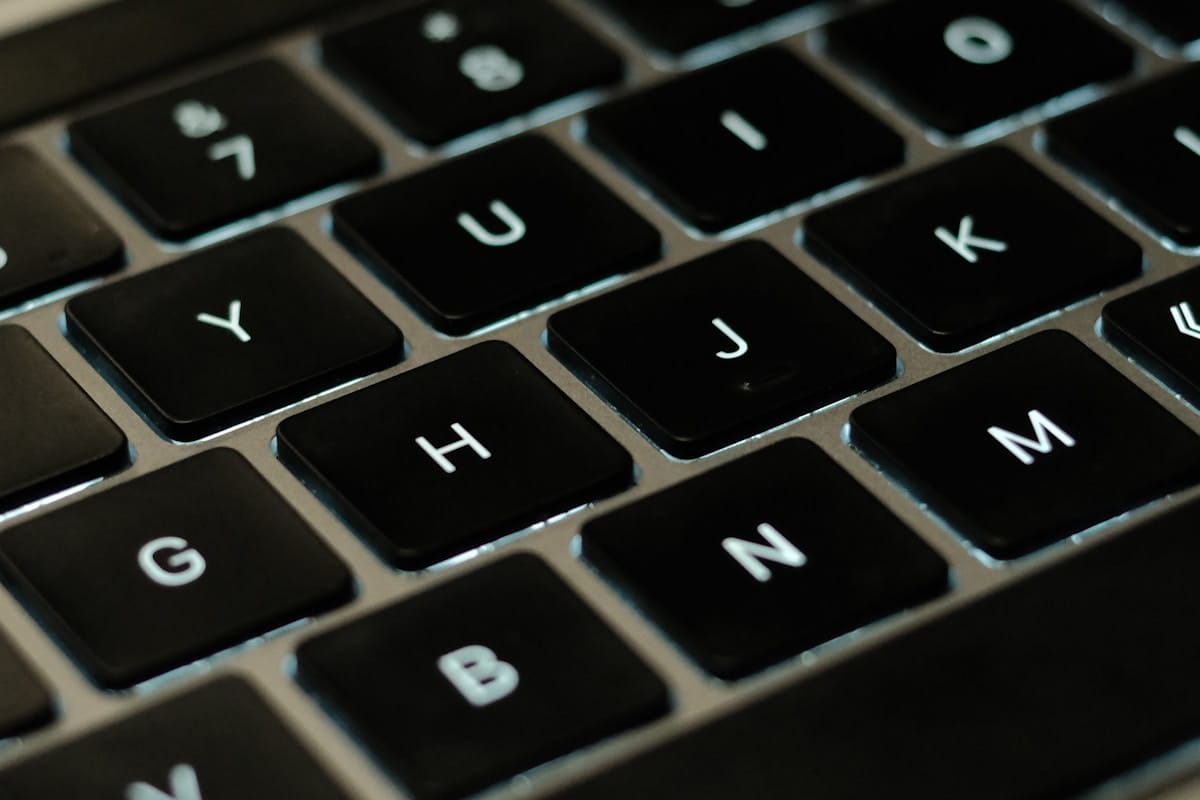 Close-up view of a black computer keyboard showing the letter keys H, J, K, Y, U, and N.