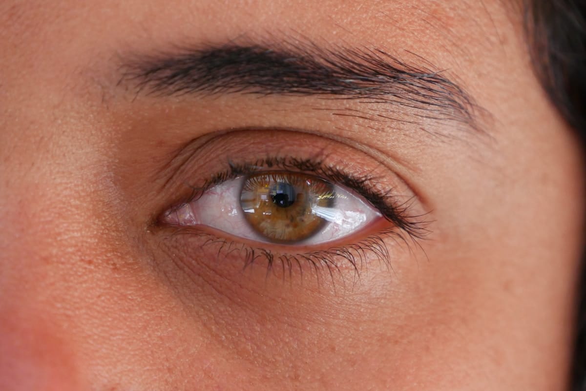 a close up of a person's brown eye