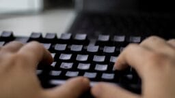 a person typing on a computer keyboard
