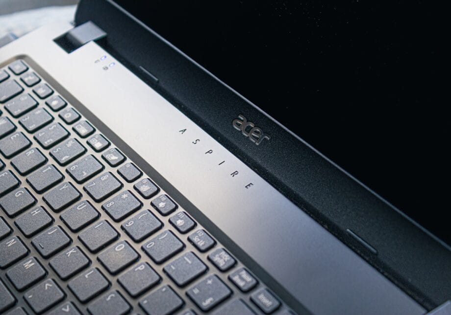 Close-up of an Acer Aspire laptop keyboard and part of the screen bezel.