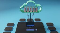 A 3D illustration of cloud computing, showing servers in a cloud connected to a desktop computer with peripheral devices.