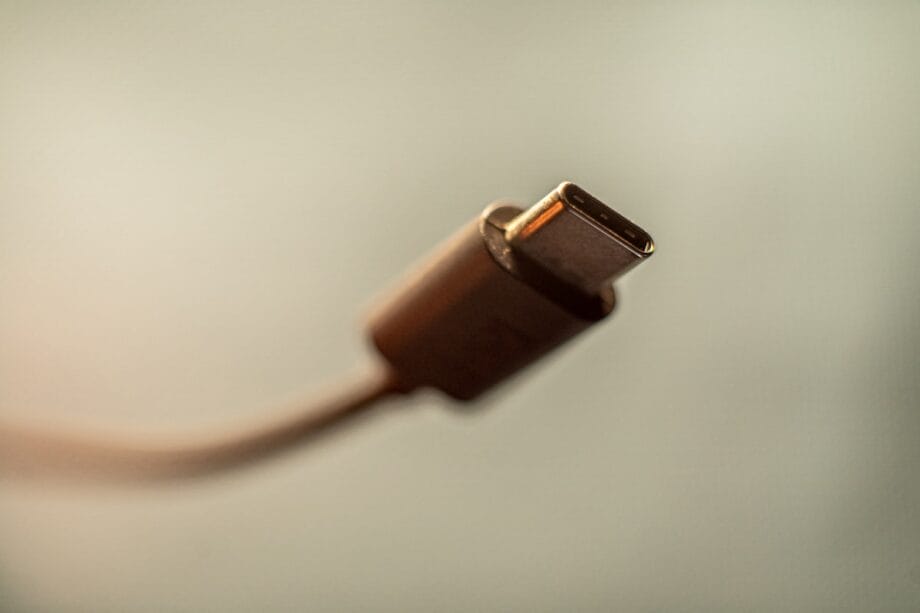 Close-up of a USB-C cable connector against a blurred neutral background.