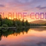 A calm lake at sunset with trees and hills in the background; large pixelated CLAUDE CODE text appears in the sky.
