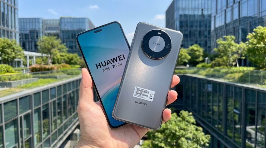 A person holds two Huawei Mate 70 Air smartphones, one showing the screen and the other showing the back, outdoors near glass buildings.